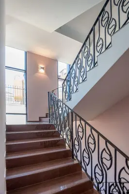 a staircase in a house with wrought iron railings at Luxury House on Buzhaka in Sozopol