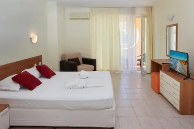 a hotel room with a bed and a television at Pollo Resort in Sunny Beach