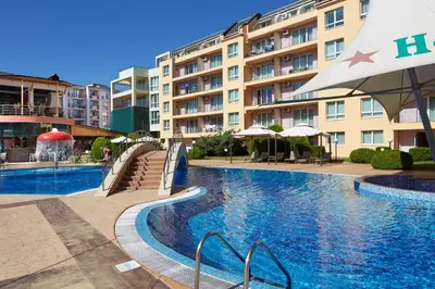 a swimming pool in front of a building at Pollo Resort in Sunny Beach