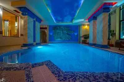 a swimming pool in a hotel with a blue ceiling at Saint George Hotel & Medical Spa in Pomorie