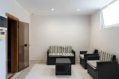 a living room with two chairs and a table at Hotel Neptun Beach in Sunny Beach