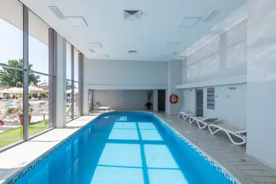 a swimming pool in a building with a pool at Hotel Neptun Beach in Sunny Beach