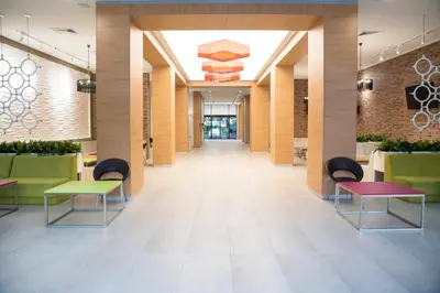 a hallway with tables and chairs in a lobby at Hotel Laguna Park & Aqua Club - All Inclusive in Sunny Beach