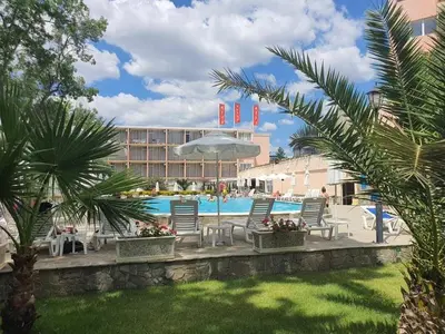 a resort with a pool and chairs and a building at Hotel Riva Park - All Inclusive in Sunny Beach