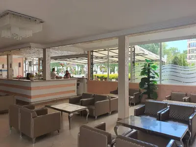 a restaurant with tables and chairs and a bar at Hotel Riva Park - All Inclusive in Sunny Beach
