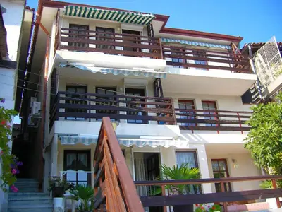 a building with balconies and stairs in front of it at Apartments Anita in Nesebar