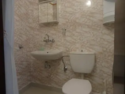 a bathroom with a toilet and a sink at Apartments Anita in Nesebar