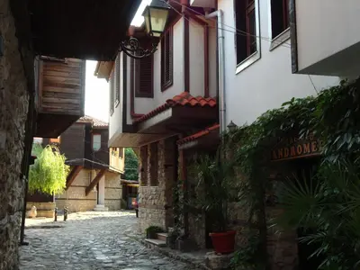 an alley in an old town with a building at Apartments Anita in Nesebar