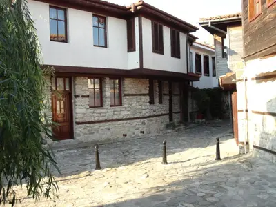 a house with a stone driveway in front of it at Apartments Anita in Nesebar