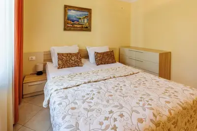 a bedroom with a bed and a picture on the wall at Apartments DreamBG in Sozopol