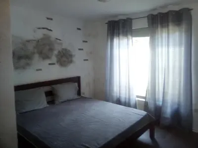 a bedroom with a bed and a window at Apartments Stefanov in Byala in Byala