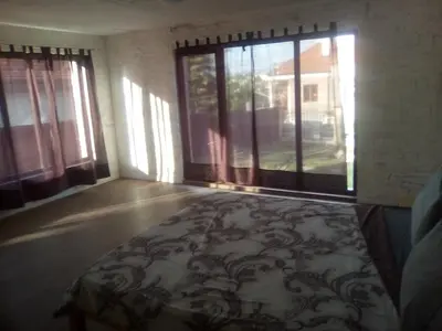 an empty room with windows and a rug on the floor at Apartments Stefanov in Byala in Byala