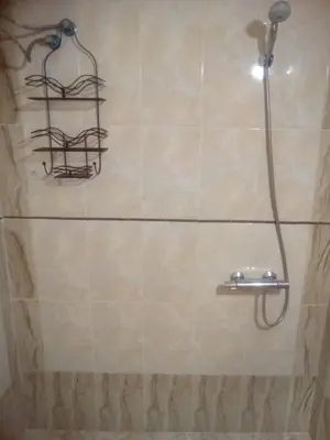 a shower with a shower head in a bathroom at Apartments Stefanov in Byala in Byala