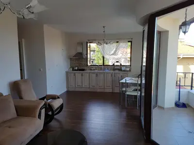 a living room with a couch and a kitchen at Apartments Stefanov in Byala in Byala