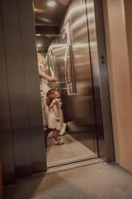 two children standing in an elevator in a train at St. Panteleimon Beach Hotel in Nesebar