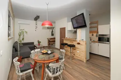 a living room with a table and a couch at Sea Crib Apartment in Varna City