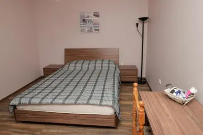 a bedroom with a bed and a table at Sea Crib Apartment in Varna City