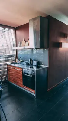 a kitchen with a sink and a stove top oven at Design Hotel Logatero in Sozopol
