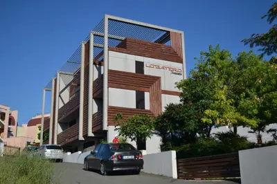 a building with cars parked in front of it at Design Hotel Logatero in Sozopol