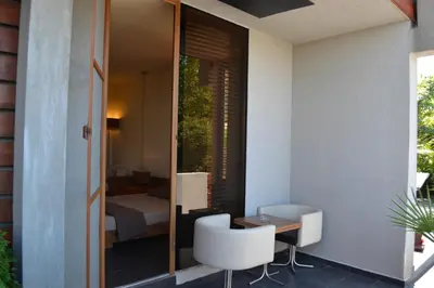 a room with a table and a chair and a bedroom at Design Hotel Logatero in Sozopol