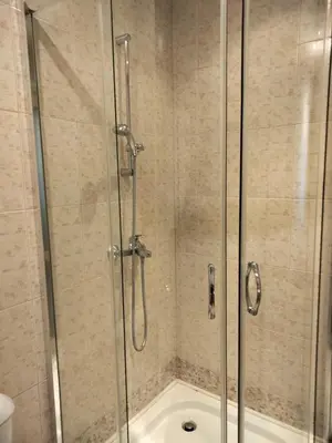a bathroom with a shower with a glass door at Avalon Apartament in Sunny Beach