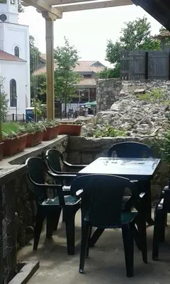 a patio with two tables and chairs and a table and chairs at Agalina Sea House in Sozopol