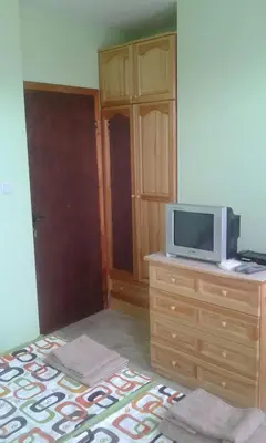 a room with a tv on a dresser with a microwave at Agalina Sea House in Sozopol