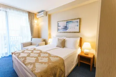 a hotel room with a bed and a window at Fjord B&B in Sozopol