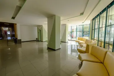 a lobby with couches and chairs in a building at Hotel Slavyanski in Sunny Beach