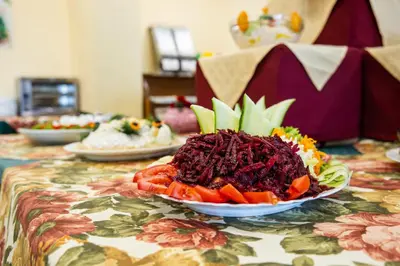 a table with a plate of food on a table at Hotel Slavyanski in Sunny Beach