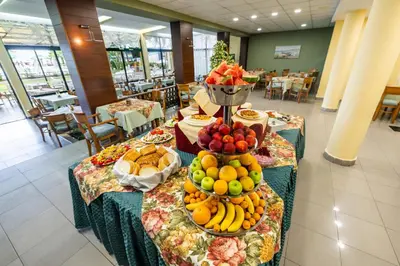 a buffet of fruit on tables in a restaurant at Hotel Slavyanski in Sunny Beach
