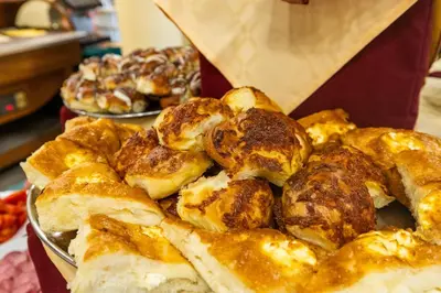 a plate of pastries on a table with other pastries at Hotel Slavyanski in Sunny Beach