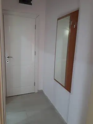 a white room with a door and a mirror at CAPUCCINO GUEST APARTMENTS - FREE PARKING and Wi-Fi in Sunny Beach