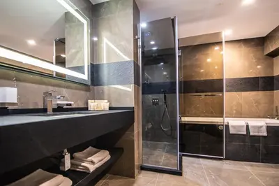a bathroom with a shower and a sink at Hotel Cherno More in Varna City