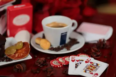 a table with a cup of coffee and a plate of food at Hotel Cherno More in Varna City