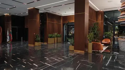 a lobby with potted plants in a building at Hotel Cherno More in Varna City