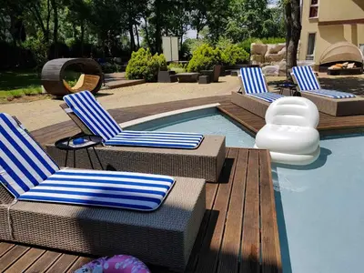 a group of chairs sitting next to a swimming pool at Sunrise Hotel in Primorsko