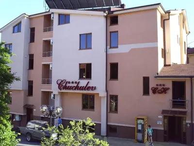 a building with a sign on the side of it at Hotel Chuchulev in Sozopol