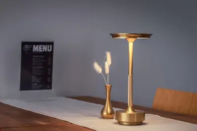 two brass vases sitting on a table with a lamp at Hotel Milan in Primorsko