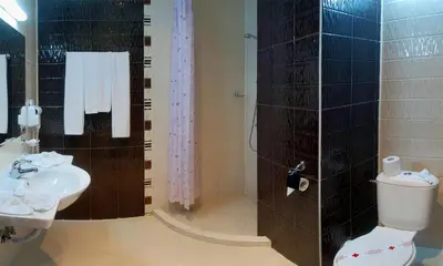 a bathroom with a toilet and a sink at Hotel Caesars Palace in Sunny Beach