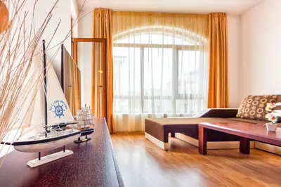 a living room with a couch and a table at Edmond Apartment-Highspeed-Internet-Free! in Aheloy