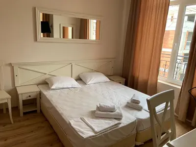 a bedroom with a bed with two towels on it at Dawn Park Complex in Sunny Beach