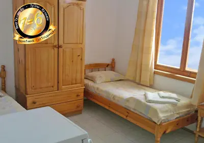 a bedroom with two twin beds and a large window at Pension Dicev in Obzor