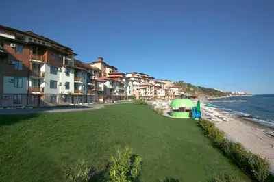 a beach with some buildings and the ocean at Болгария, г.Свети Влас, к.
