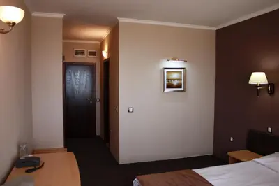 a hotel room with a bed and a door at Guest House Palazzo in Byala