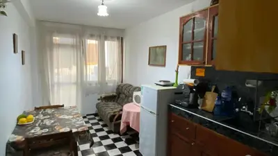 a kitchen with a couch and a table in a room at Аria B&B in Burgas City