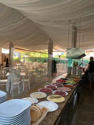 a buffet line with plates of food on it at Hotel Kamenec in Kiten
