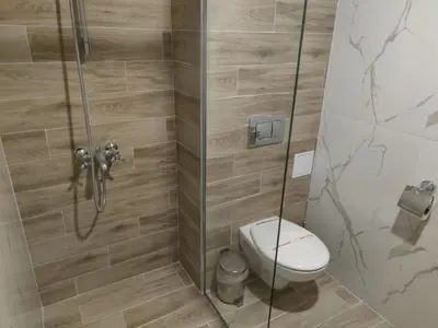 a bathroom with a shower with a toilet at Hotel Kamenec in Kiten