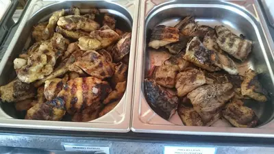 two trays of food with chicken and other foods at Hotel Sapphire in Primorsko