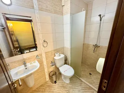 a bathroom with a toilet and a sink and a shower at Family Hotel Teos in Kiten